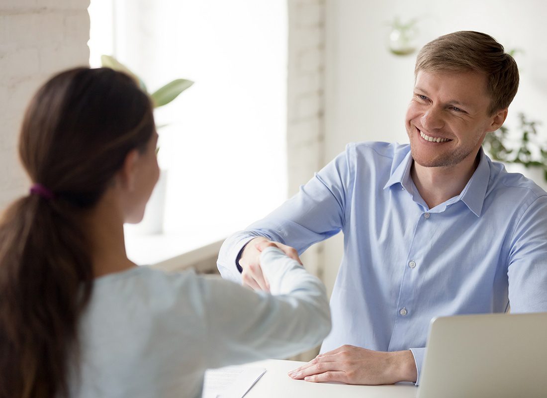Contact - Friendly Agent Shaking Hands With a Client